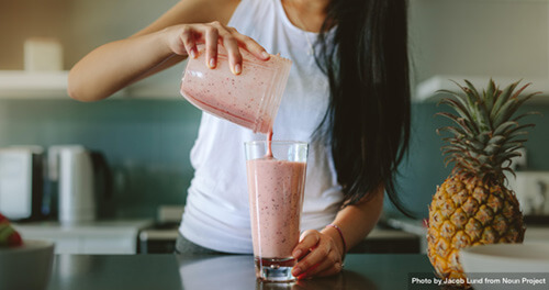 Someone make a smoothie and pour it into a glass because nutrition is important in early recovery.