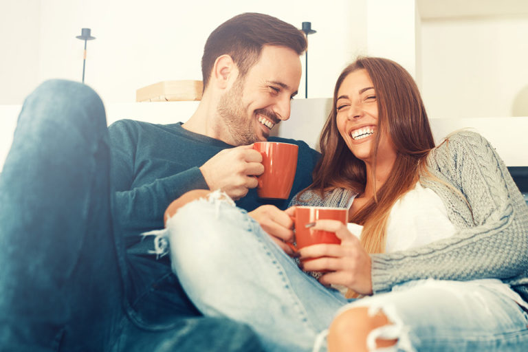 Cheerful young couple in the morning at home.